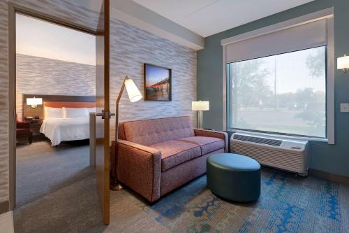 微风湾Home2 Suites by Hilton Gulf Breeze Pensacola Area, FL的客厅配有沙发和1张床