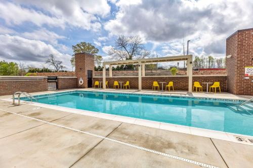 罗利Home2 Suites By Hilton Raleigh State Arena的一个带椅子的游泳池和一个凉亭