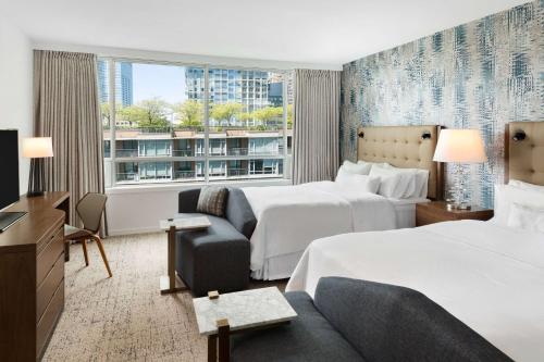 温哥华Hilton Vancouver Downtown, BC, Canada的酒店客房,设有两张床和一张沙发