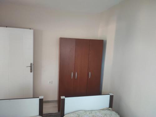 特拉布宗Hamsiköy Merkez Daire的一间卧室设有两张床和棕色橱柜