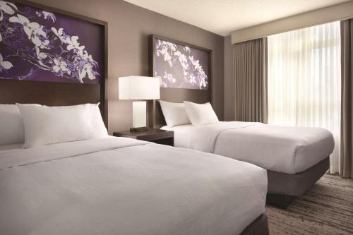 亚特兰大Embassy Suites by Hilton Atlanta at Centennial Olympic Park的酒店客房设有两张床和窗户。