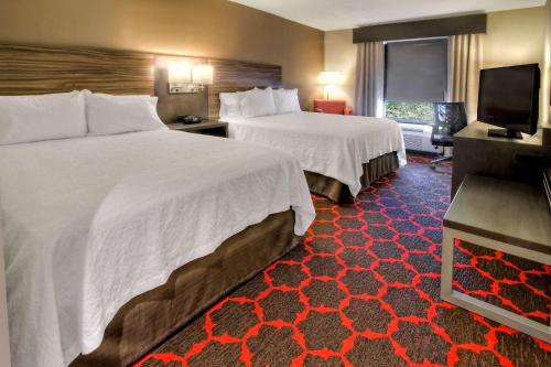 库克维尔库克维尔汉普顿酒店的酒店客房设有两张床和一台平面电视。