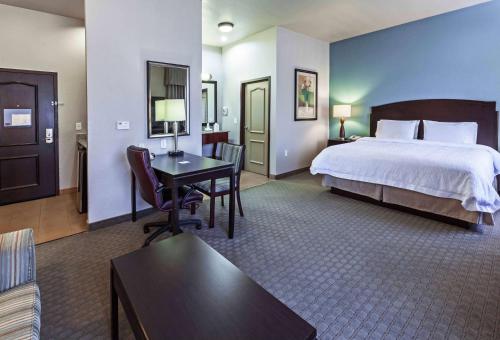 Clute杰克逊湖-克鲁特汉普顿套房酒店的大型酒店客房,配有一张床和一张书桌
