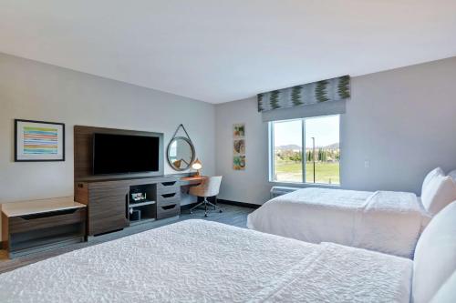 丘拉维斯塔Hampton Inn Chula Vista Eastlake的一间卧室配有两张床和一台平面电视