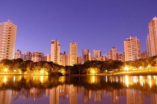 戈亚尼亚Hostel Bimba Goiânia - Unidade 02的城市天际线,夜晚有湖泊和建筑