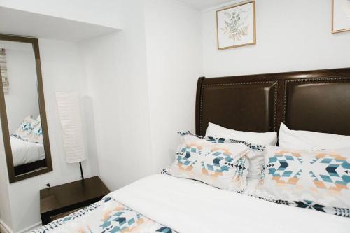 基奇纳Feeling Home, while away的一间卧室配有一张带棕色床头板和枕头的床。