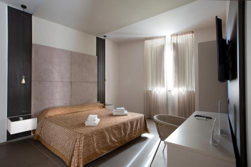 那不勒斯钻石酒店的一间卧室,卧室内配有一张床和一把椅子