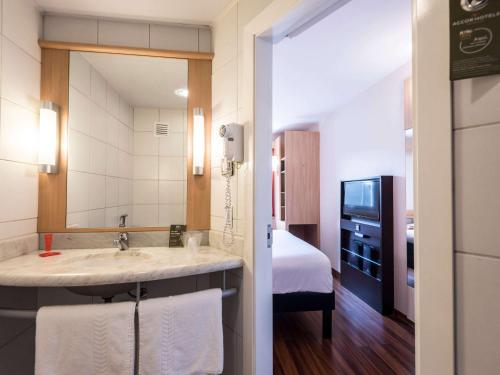 利马宜必思拉尔科米拉弗洛雷斯酒店的一间带水槽和床的酒店浴室