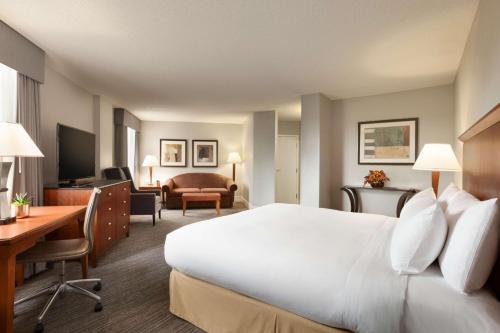 圣路易斯帕克明尼阿波利斯公园双树酒店的酒店客房设有一张白色大床和一张书桌