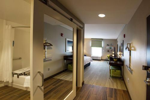 福克斯伯勒Hampton Inn & Suites/Foxborough/Mansfield的一间卧室配有一张床和一张书桌