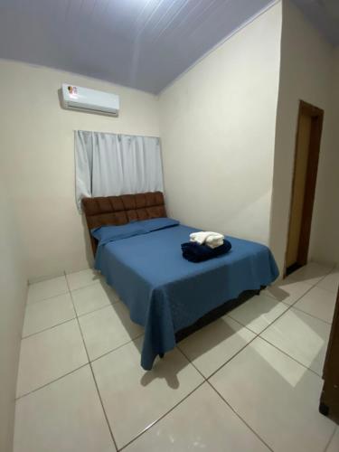 帕尔马斯Recanto Sonho - PX Palmas Brasil的一间白色客房内的蓝色床卧室