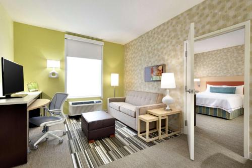 独立市独立城克利夫兰希尔顿欣庭套房酒店的配有一张床和一张书桌的酒店客房