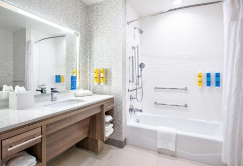 威奇托福尔斯Home2 Suites By Hilton Wichita Falls, Tx的带浴缸、水槽和淋浴的浴室