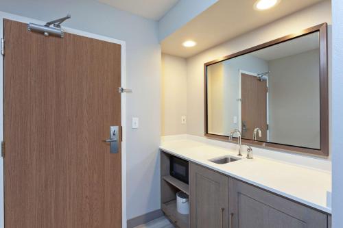 贺茂沙海滩赫莫萨比奇汉普顿套房酒店的一间带水槽和镜子的浴室