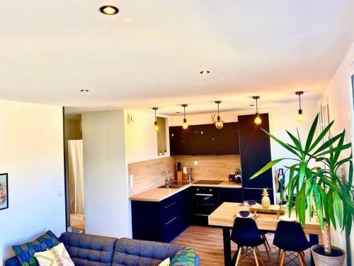 卢尔德*Superbe appartement moderne*的厨房以及带蓝色沙发的起居室。