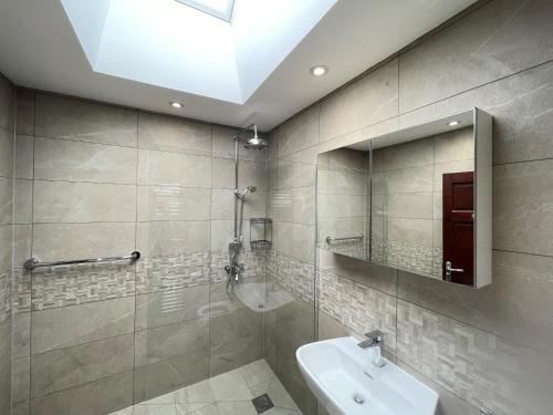 阿德尔斯通Addlestone Tranquil Spacious Three Bedroom Bungalow的一间带水槽和镜子的浴室