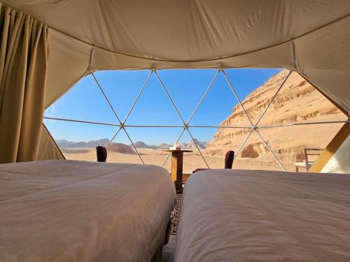 瓦迪拉姆Sun Luxury Rum Camp的帐篷内的两张床,享有沙漠美景