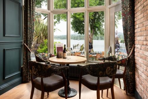 安布尔塞德The Waterhead Inn- The Inn Collection Group的窗户客房内的桌椅