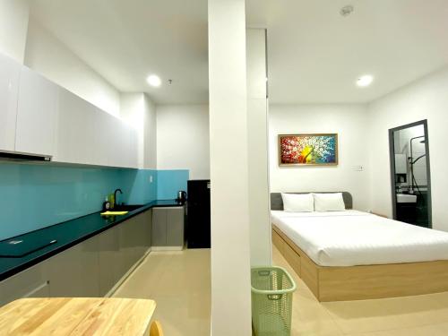 胡志明市Chanh Huy Apartments & Hotel的一间带床的小卧室和一间厨房