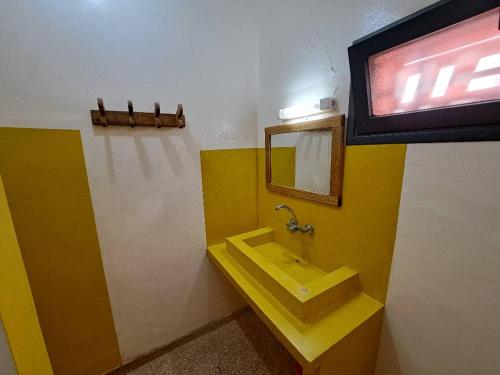 OuoranLe Kenkeni的浴室设有黄色水槽和镜子