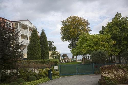 赛巴特班森Haus Rolandseck - FeWo 03的一座带栅栏和树木的大型白色房屋