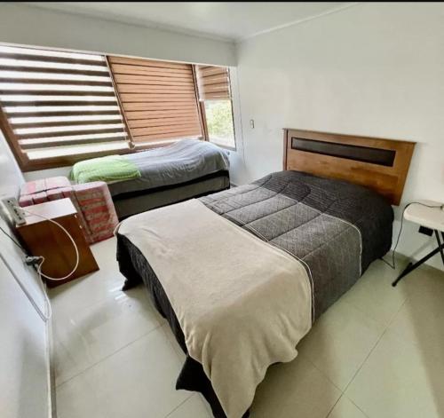 维纳德马Departamento Reñaca的一间卧室设有两张床和窗户。