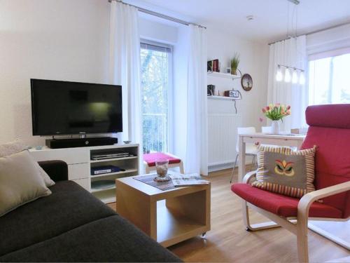 赛巴特班森Strandoase - FeWo 21的带沙发和平面电视的客厅