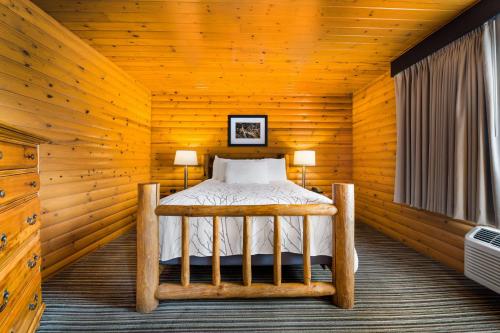 MaustonBest Western Park Oasis Inn的小木屋内一间卧室,配有一张床