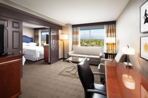 波莫纳Sheraton Fairplex Suites & Conference Center的酒店客房设有床和客厅。