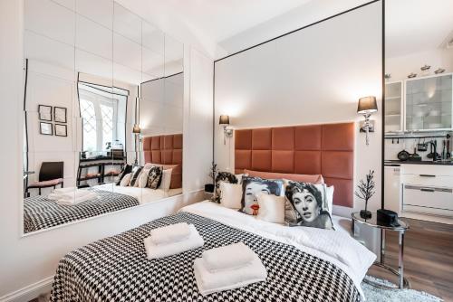 华沙Premium Apart Varsovia Alice 2的一间卧室配有一张大床和镜子