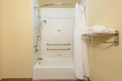 列克星敦列克星敦市中心区基恩兰智选套房酒店的带淋浴和白色浴缸的浴室