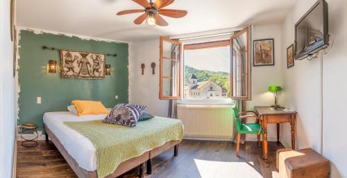 瓦尔瑟里恩河畔贝勒加尔德Hotel-Restaurant Le Sorgia的一间卧室配有一张床、一张桌子和一个窗户。