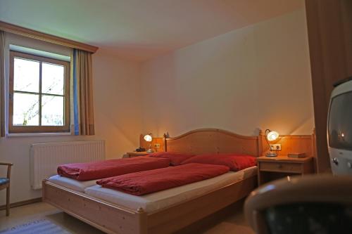 格绍韦林芬尼公寓的一间卧室配有一张带红色床单的床和一扇窗户。