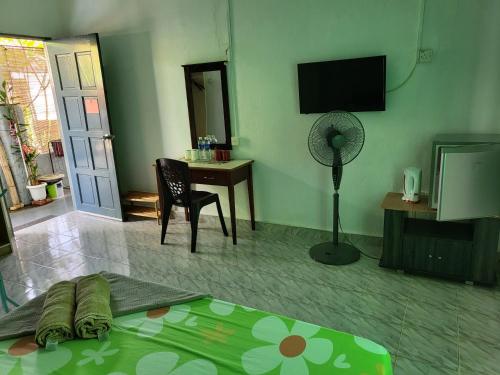 珍南海滩Langkawi Village Budget Rooms的客厅配有床和风扇
