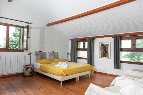 Gaillac-ToulzaChaumarty Ecogîtes©的一间设有床铺的卧室,位于带窗户的房间内