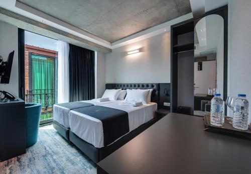 第比利斯Mit Hotel Tbilisi的一间卧室设有一张大床和一个大窗户