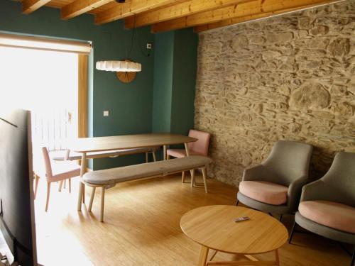 埃斯波特El Corral de Baró的一间设有桌椅和石墙的用餐室
