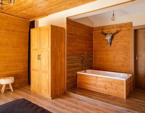 RakitovoForest Lux Boutique Villas的浴室配有带鹿头的浴缸,墙上设有鹿头