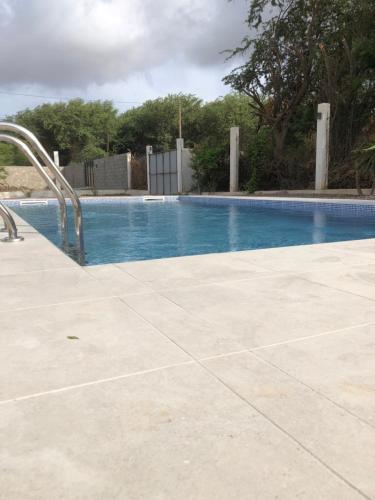 LazarettoCasa Palmeira的一个带蓝色游泳池的大型游泳池