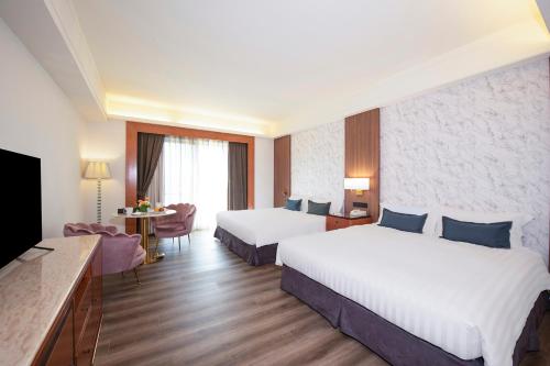 台北台北汉普顿酒店的酒店客房设有两张床和电视。