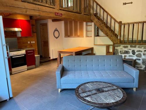 Saint-DiéryLa clé des champs de Laumont的客厅设有蓝色沙发,厨房设有