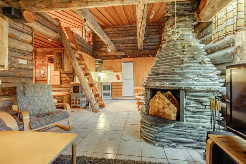 凯米耶尔维Kelohonkahuoneisto Käkriäinen B的小木屋内带石制壁炉的客厅