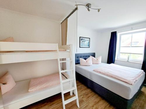 宾茨祖尔阿尔腾博斯特普罗拉酒店的一间带双层床和梯子的小卧室
