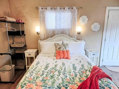 温泉城#03 - Fantastic Lakeside Studio Cottage- Pet Friendly的一间卧室配有一张带花卉床罩的床