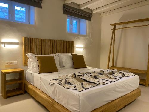 阿吉亚艾里尼帕罗Nerea Sunset View Apartment的一间卧室配有一张大床和木制床头板