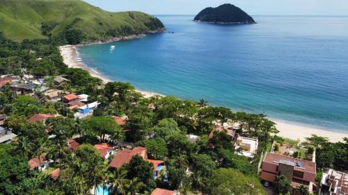 稻克稻克格兰德Vila dos Tangarás, Casa 1 Praia, a 30m do mar的享有海滩的空中景致,设有房屋和海洋