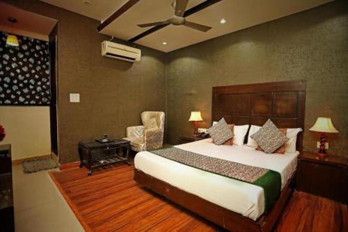 新德里Staybook Hotel Aira, Paharganj, New Delhi Railway Station的一间卧室配有一张大床和风扇