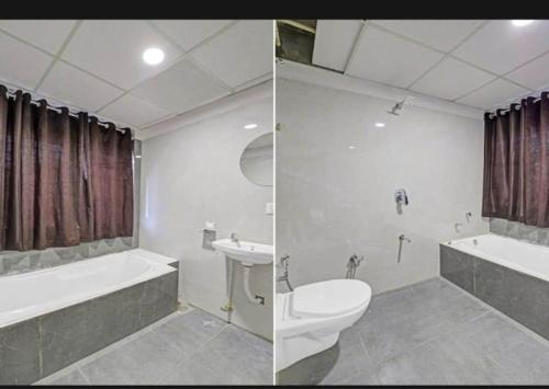 艾哈迈达巴德hotel stay inn的浴室配有卫生间、浴缸和水槽。