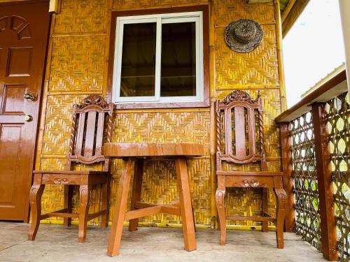 BatuanJazz Ferme Inn Batuan Bohol的房屋设有两把椅子和窗户
