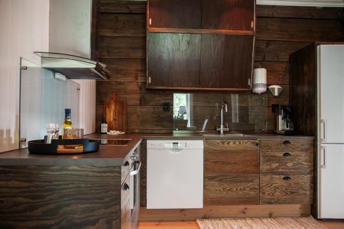 ViksdalenTuftegarden的厨房配有白色冰箱和木制橱柜。